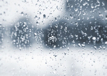 Rain drops on the glass window. Blurred background