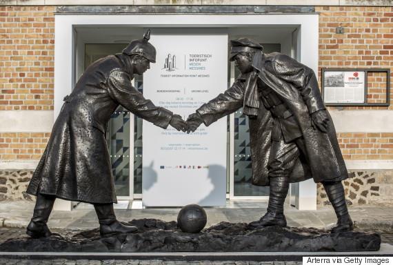 Statue by Andrew Edwards representing British and German soldiers shaking hands during World War One Christmas Truce in front of the Mesen / Messines tourist information point