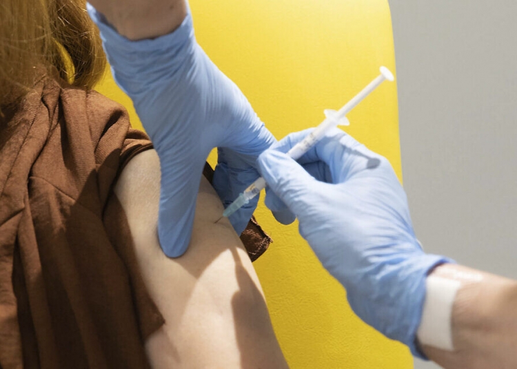 FILE - In this undated file photo issued by the University of Oxford, a volunteer is administered the coronavirus vaccine developed by AstraZeneca and Oxford University, in Oxford, England. New results released Tuesday, Dec. 8, 2020, on the possible COVID-19 vaccine suggest it is safe and about 70% effective. (John Cairns/University of Oxford via AP, File)