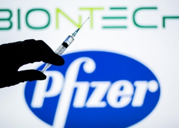SPAIN - 2021/01/18: In this illustration, a hand of a person seen holding a syringe in front of the Pfizer and BioNTech logo.
Spain begins to administer the second dose of the Pfizer and BioNTech drug vaccine and the first dose (35,700 doses) of Moderna's drug has been incorporated, which also requires two injections per person. (Photo Illustration by Thiago Prudêncio/SOPA Images/LightRocket via Getty Images)