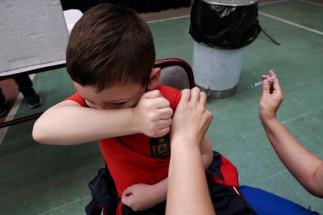 A child prepares to receive a dose of Sinovac's CoronaVac COVID-19 vaccine as the Chilean sanitary authority continue the vaccination campaign against the coronavirus disease for 6 to 11-year-olds, in Santiago, Chile October 29, 2021. REUTERS/Ivan Alvarado     TPX IMAGES OF THE DAY