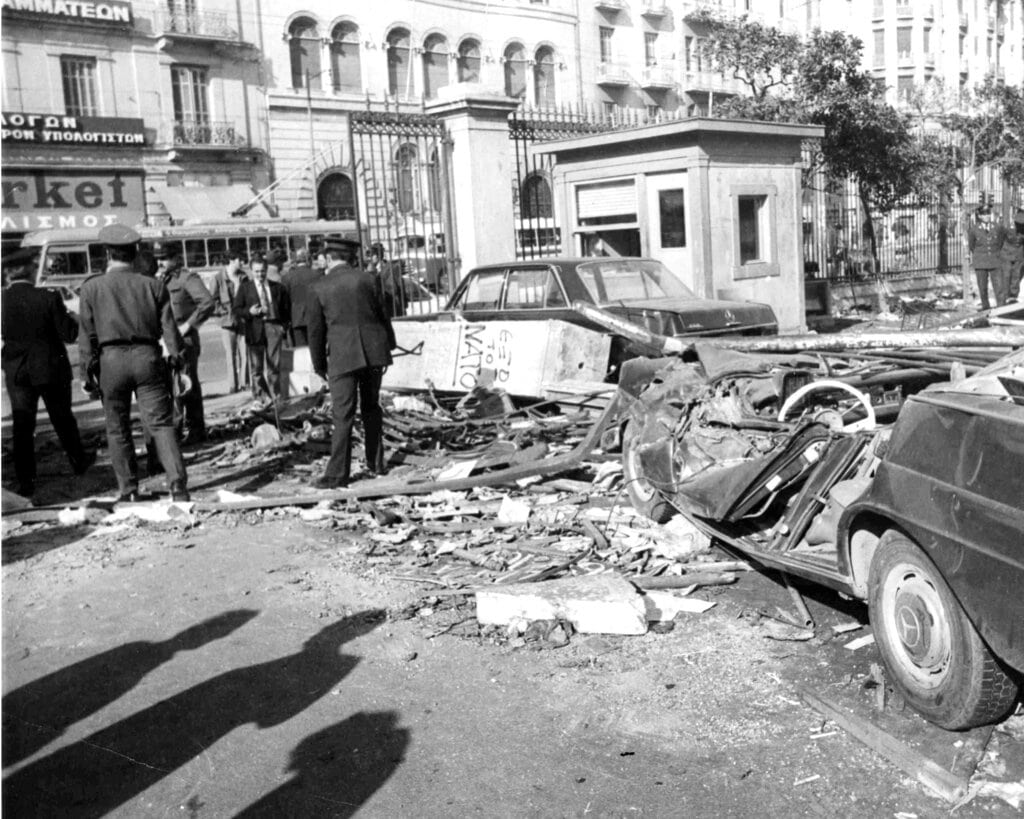 Wrecked cars stand among the debris inside the gateway of the Polytechnic Institute, in Athens, on Nov. 18, 1973, after police and troops drove out students who had barricaded themselves inside.  Nine people have been killed during anti-government troubles. (AP Photo)