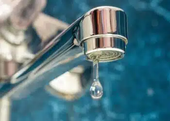 A drop of water drips from a leaky faucet.